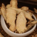Dried ginger slices in a white bowl