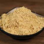 Ground ginger in a black bowl