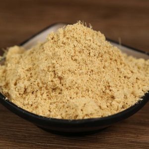 Ground ginger in a black bowl