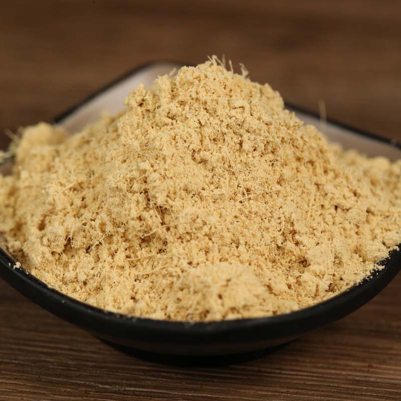 Ground ginger in a black bowl