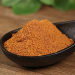 Ground cinnamon in a black bowl