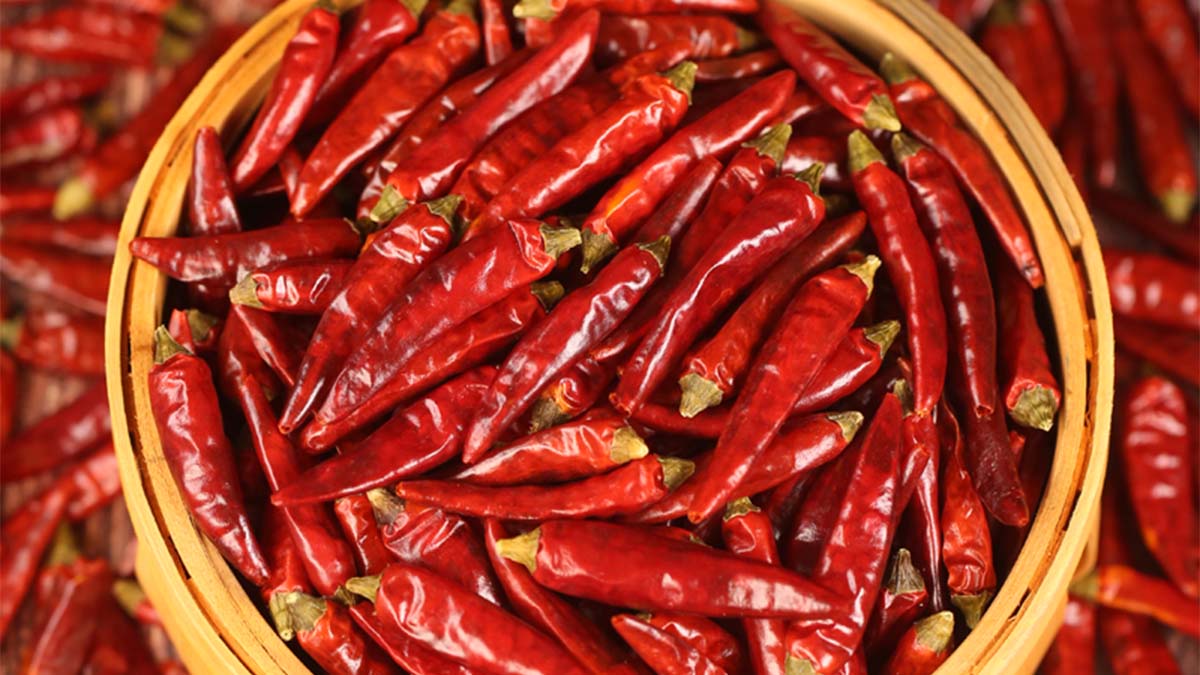 Whole dried red chili peppers in a bamboo basket