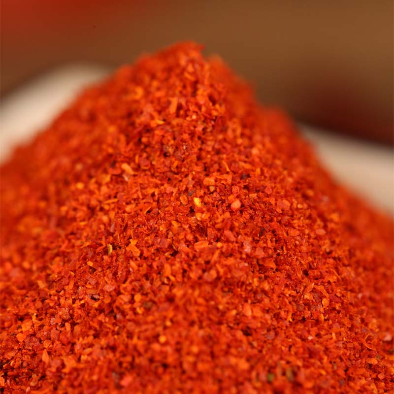 Super hot fine chili powder heaped in a close-up mound