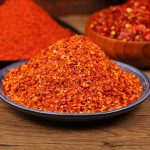 Super hot coarse chili powder heaped on a blue-rimmed plate