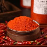 Huaxi fine-ground chili powder in a wooden bowl