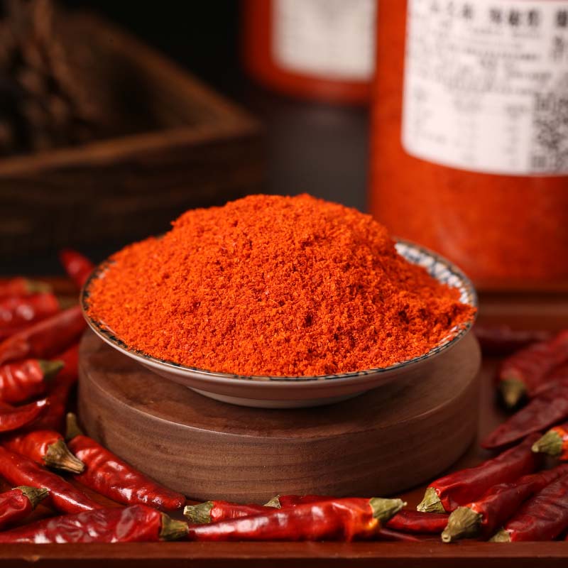 Huaxi fine-ground chili powder in a wooden bowl