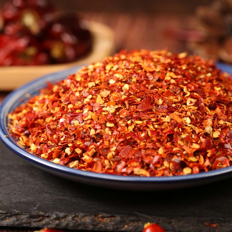 Huaxi coarse-ground chili powder in a blue rimmed dish