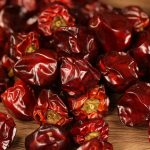Denglongjiao dried chili peppers in close-up on a wooden board