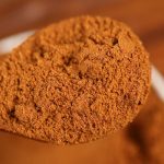 Ground star anise on a wooden spoon
