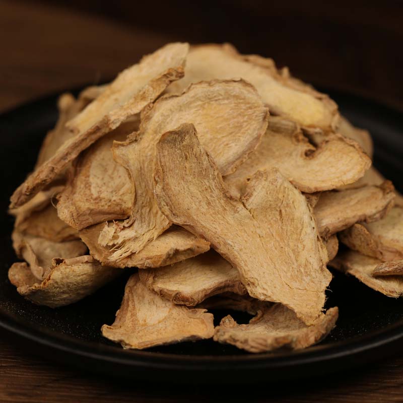 Dried ginger slices on a black plate