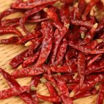 Xiaomila dried chili peppers scattered on a wooden table