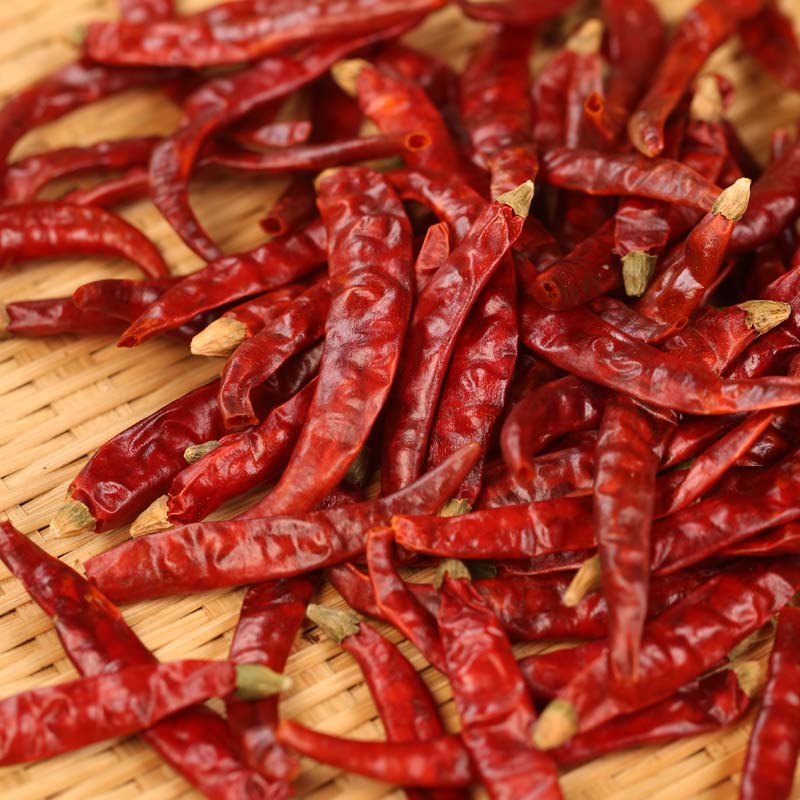 Xiaomila dried chili peppers scattered on a wooden table