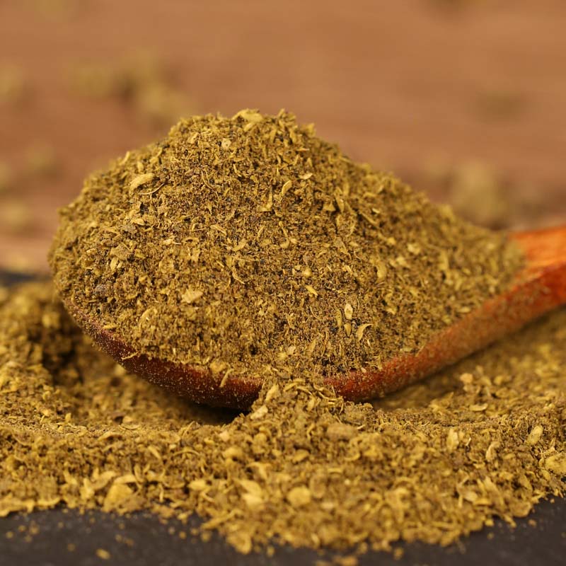 Green Sichuan pepper powder on a wooden spoon