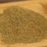 Ground cumin mounded on a wooden board