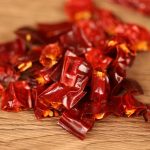Erjingtiao dried chili segments scattered on a wooden table