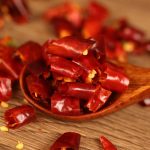 Mantianxing dried chili segments on a wooden spoon