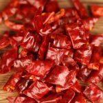 Xiaomila dried chili segments scattered on a wooden table