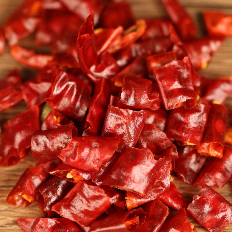 Xiaomila dried chili segments scattered on a wooden table
