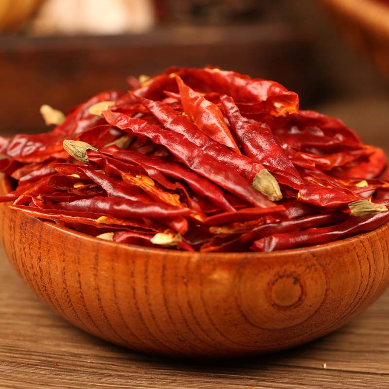 Xiaomila chili threads in a wooden bowl on a table
