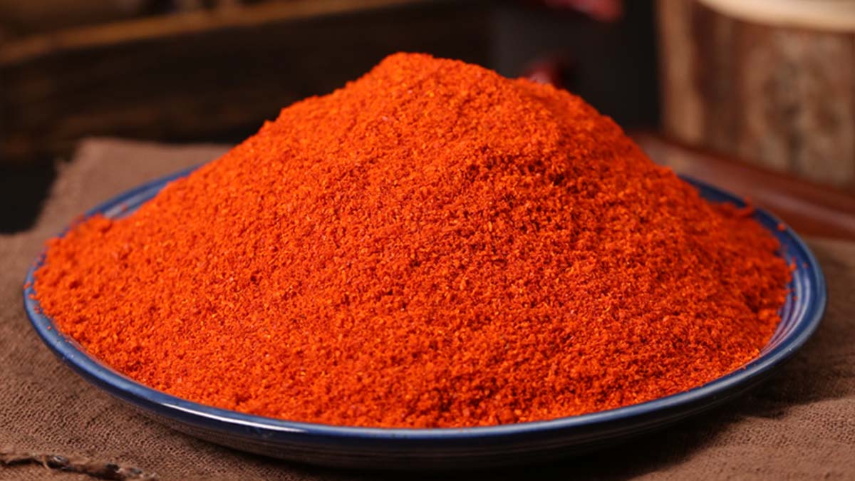 Fine red chili powder heaped on a blue-rimmed plate