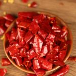 Xinyidai dried chili segments in a wooden bowl