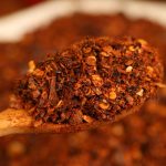 Roasted chili powder on a wooden spoon