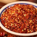 Huaxi coarse-ground chili powder in a white bowl