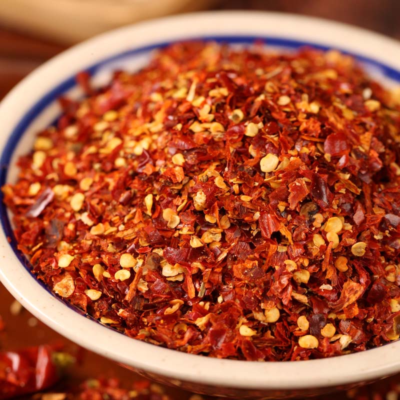 Huaxi coarse-ground chili powder in a white bowl