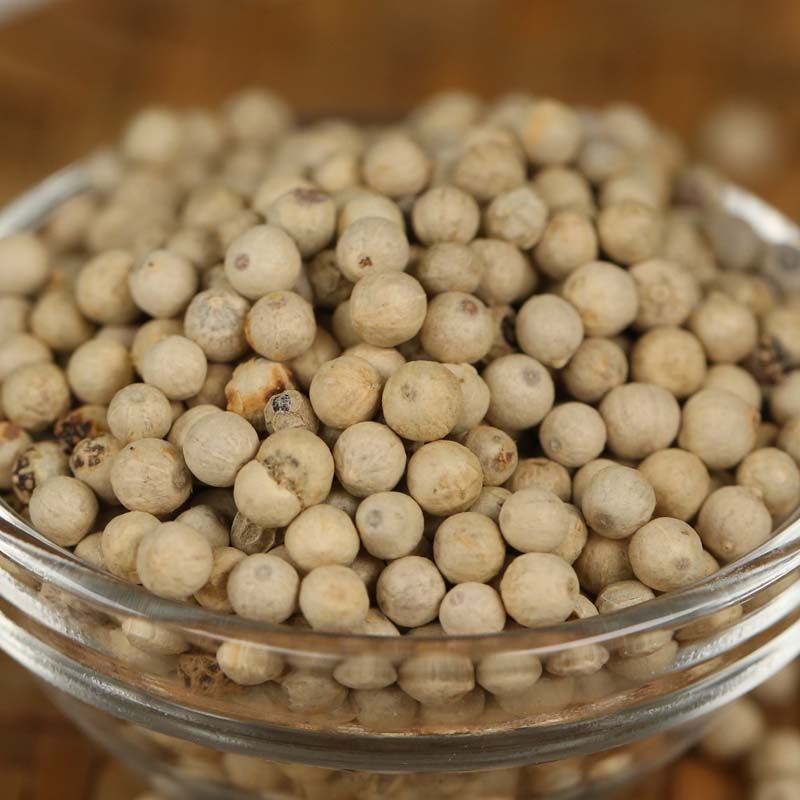 White peppercorns in a glass bowl