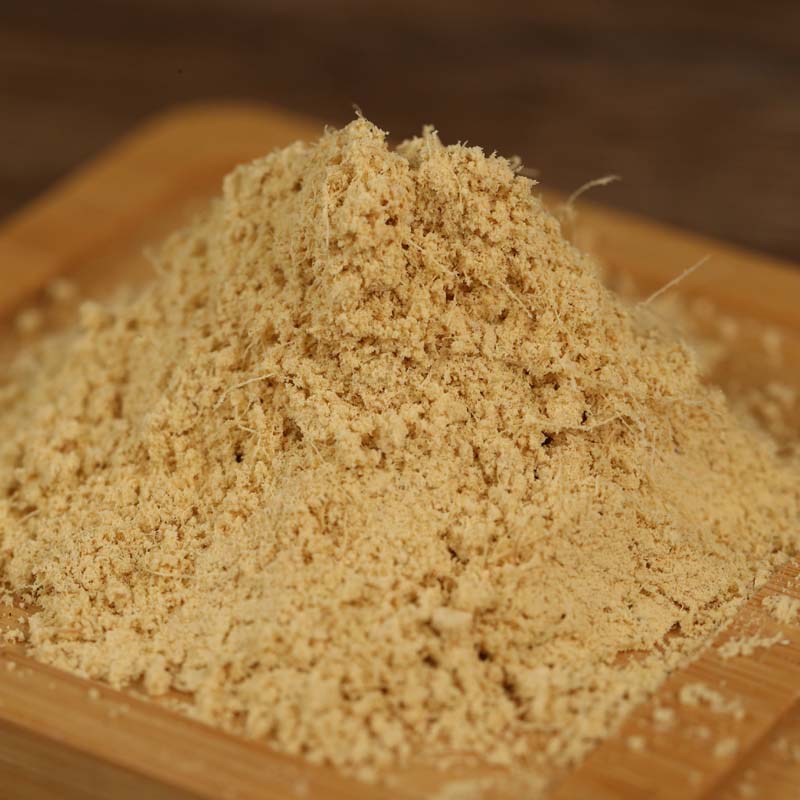 Ground ginger mounded on a wooden board