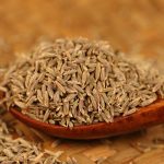 Cumin seeds in a wooden bowl