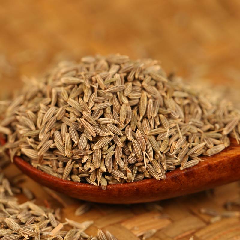 Cumin seeds in a wooden bowl