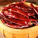 Huaxi dried chili peppers in a wooden bucket