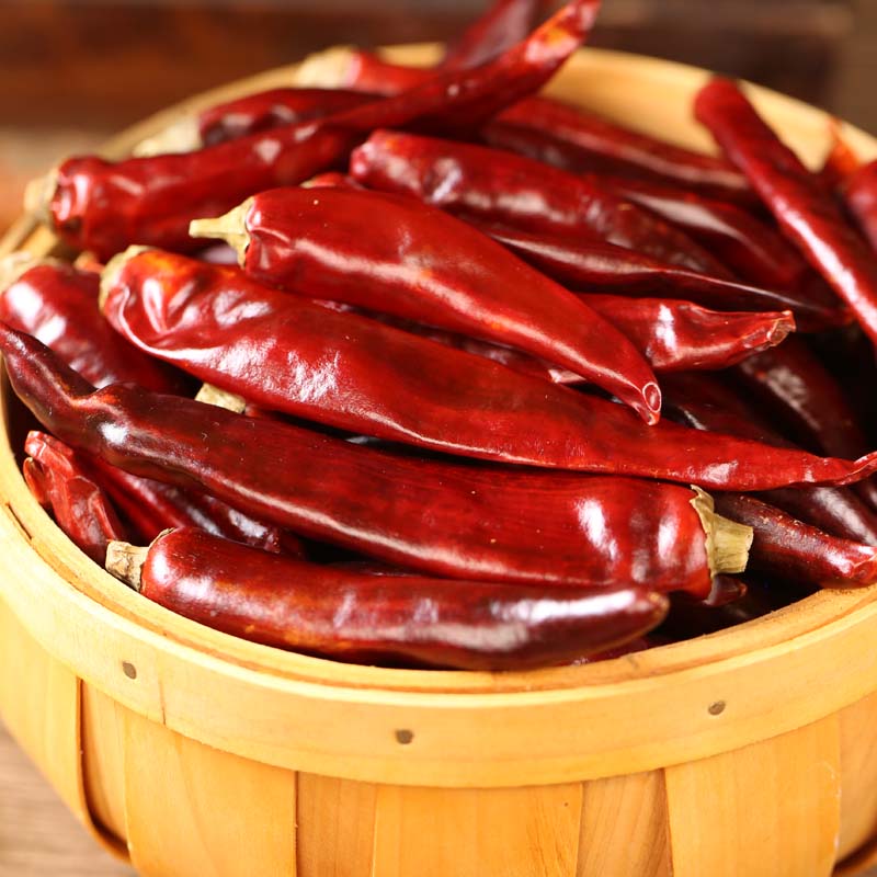 Huaxi dried chili peppers in a wooden bucket