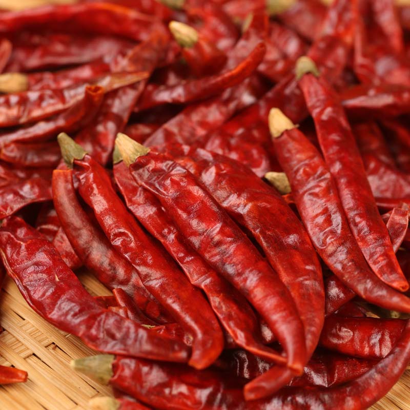 Xiaomila dried chili peppers spread on a bamboo mat