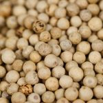 White peppercorns heaped in close-up