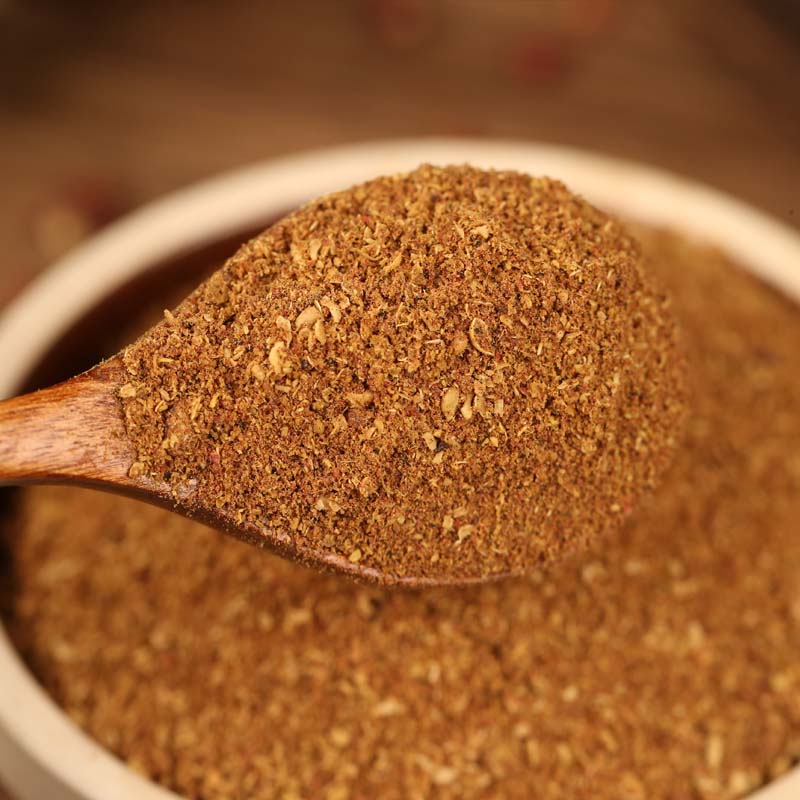 Red Sichuan pepper powder on a wooden spoon