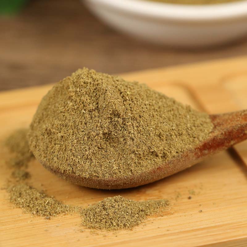 Ground cumin on a wooden spoon