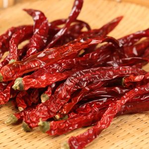 Erjingtiao dried chili peppers spread on a bamboo mat