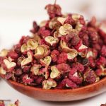 Meihua red Sichuan peppercorns heaped on a wooden spoon