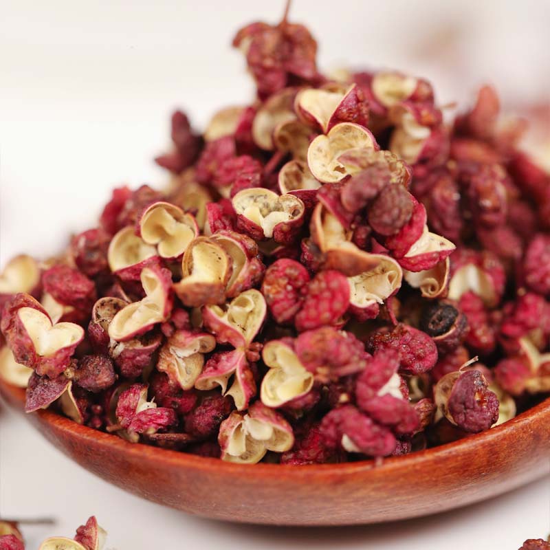Meihua red Sichuan peppercorns heaped on a wooden spoon