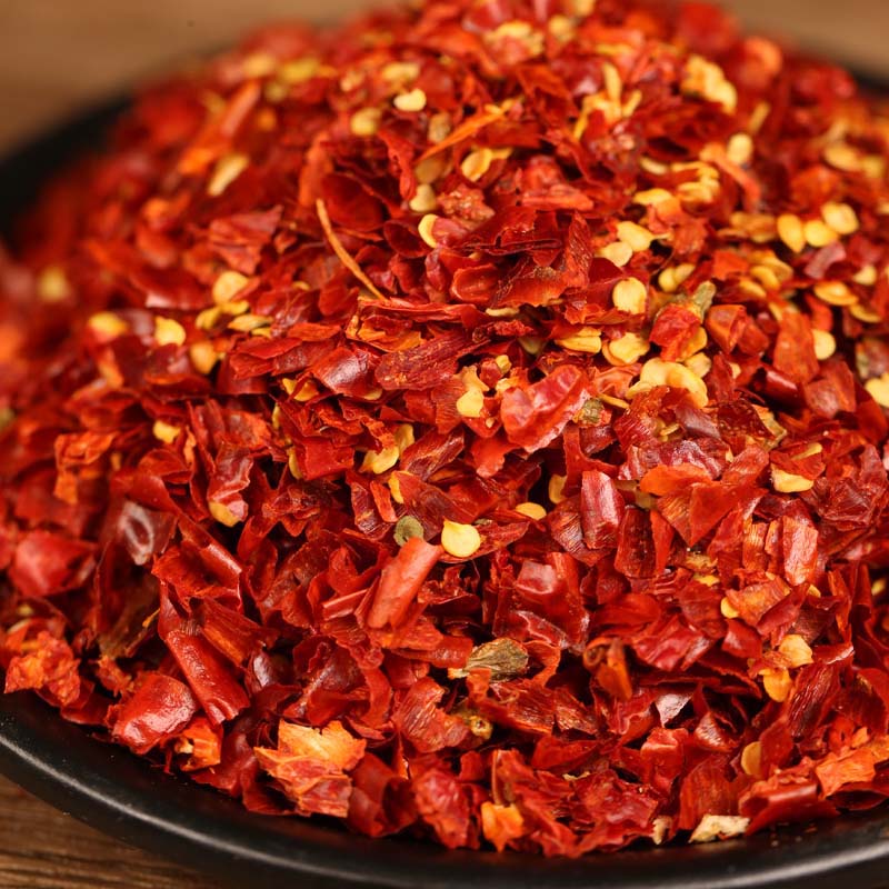 Xiaomila crushed chili flakes heaped in a black bowl