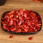 Xiaomila dried chili segments on a black plate