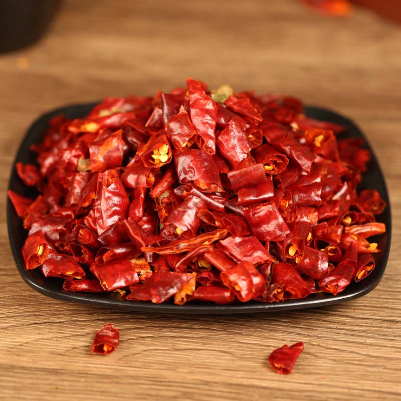 Xiaomila dried chili segments on a black plate