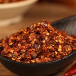 Roasted chili powder in a black bowl