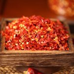 Erjingtiao coarse chili flakes filling a wooden tray
