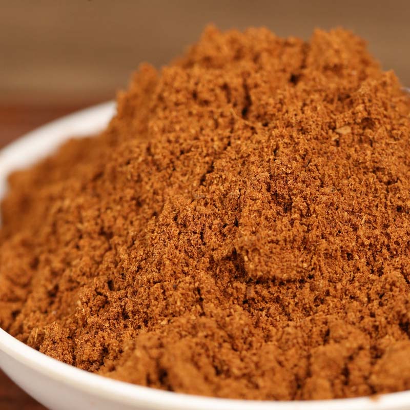 Ground star anise mounded in a white bowl