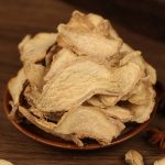 Dried ginger slices in a brown bowl
