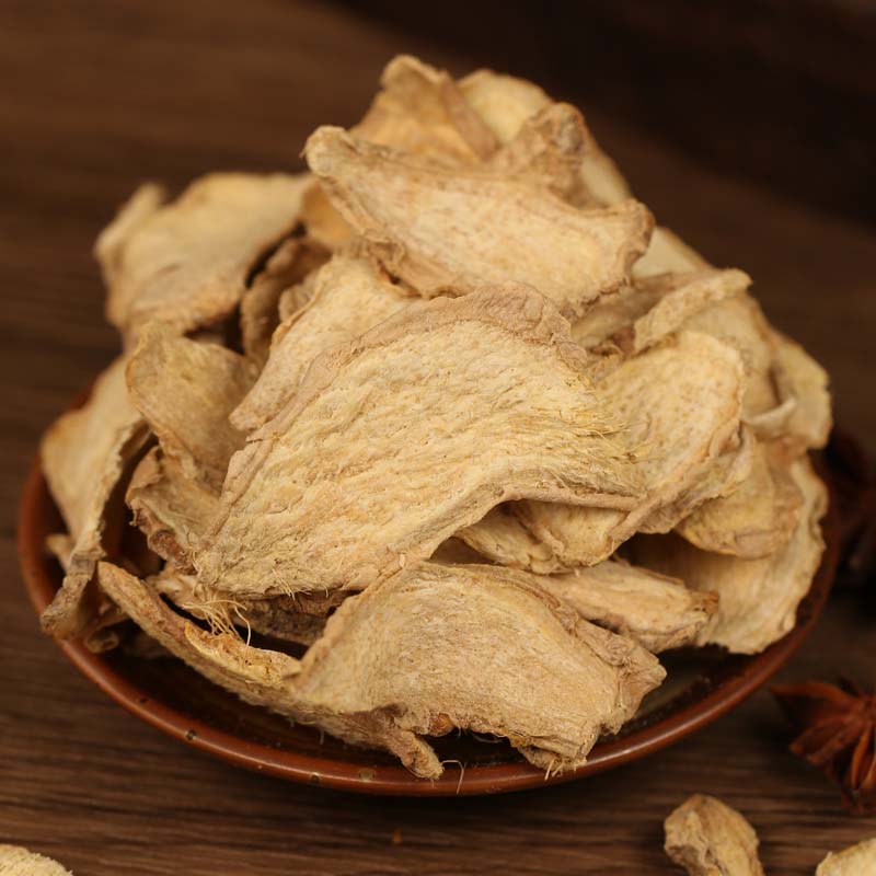 Dried ginger slices in a brown bowl