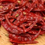 Xiaomila dried chili peppers heaped on a bamboo mat